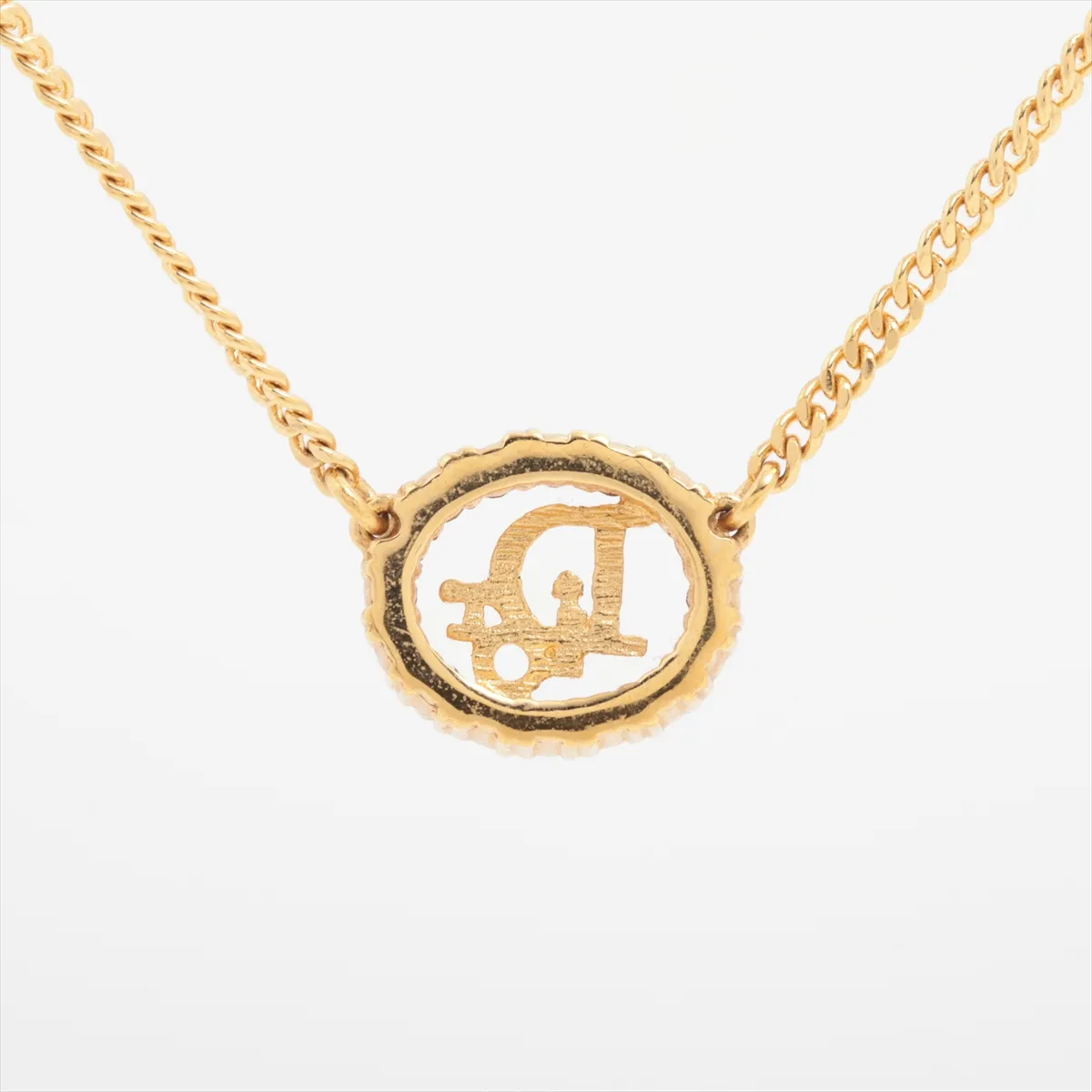 logo necklace, gold plated with rhinestones. Shows wear, tarnishing, and stains. — view 2