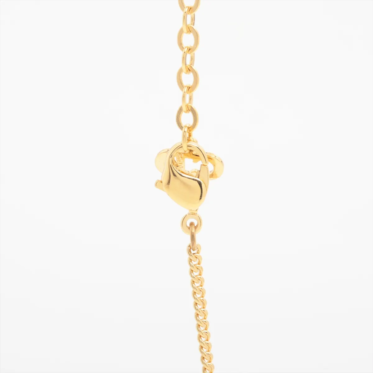 logo necklace, gold plated with rhinestones. Shows wear, tarnishing, and stains. — view 3