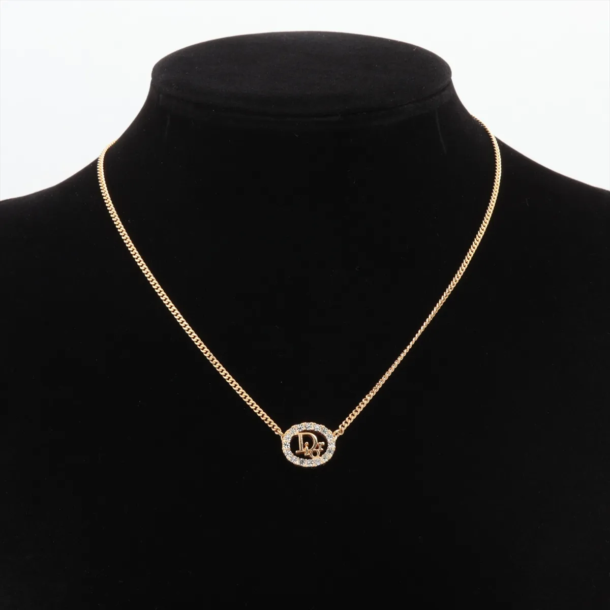 logo necklace, gold plated with rhinestones. Shows wear, tarnishing, and stains. — view 5