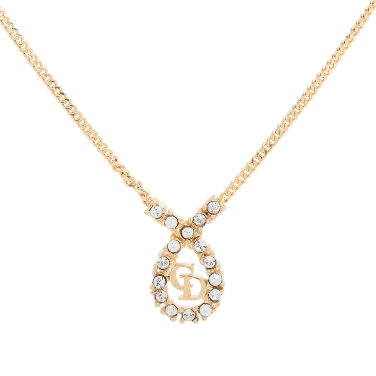 CD logo necklace, gold-plated with rhinestones. Shows signs of wear,