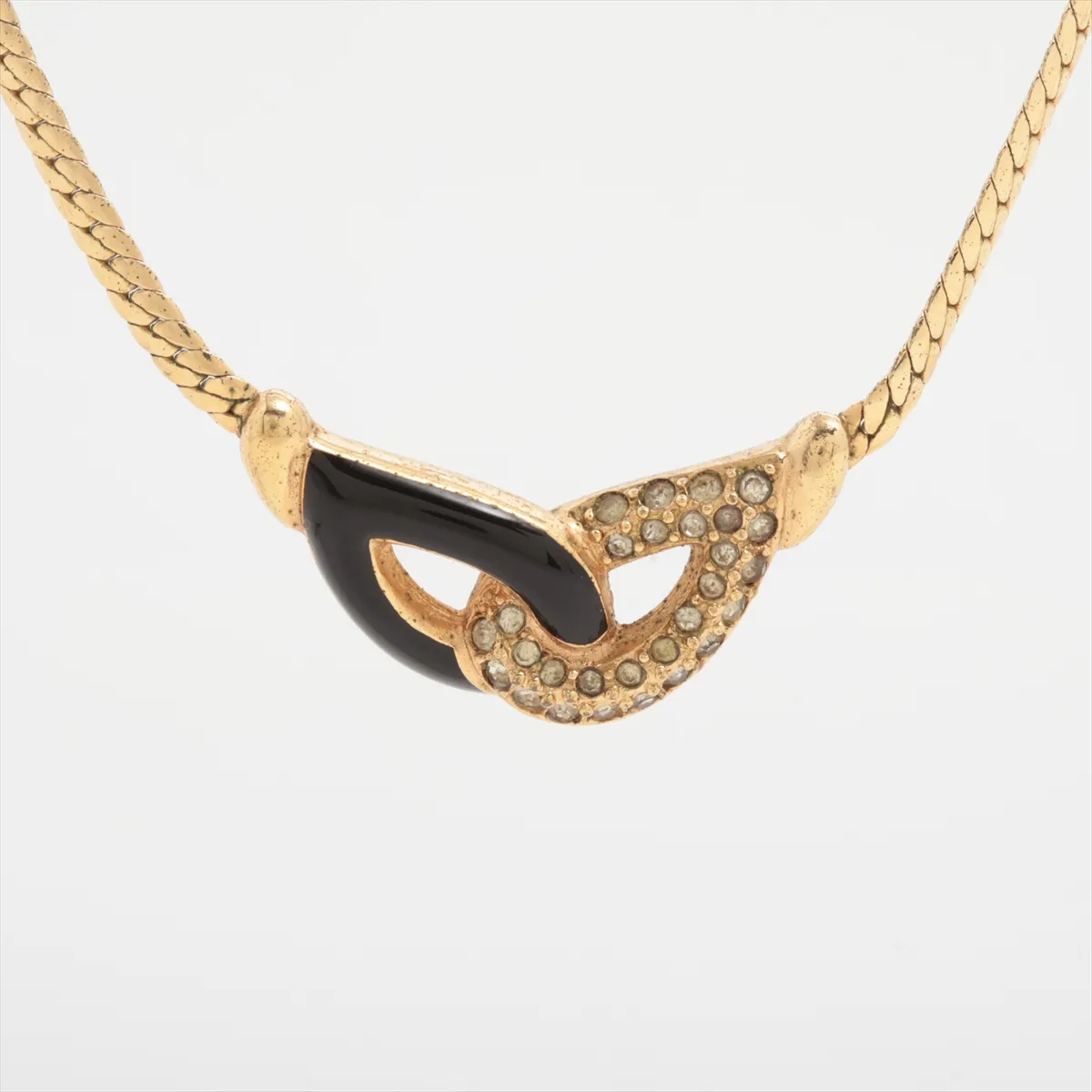 necklace, gold and black, with rhinestones. Shows signs of wear including