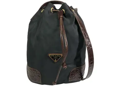 drawstring shoulder bag with triangular logo plate and crocodile embossed leather.