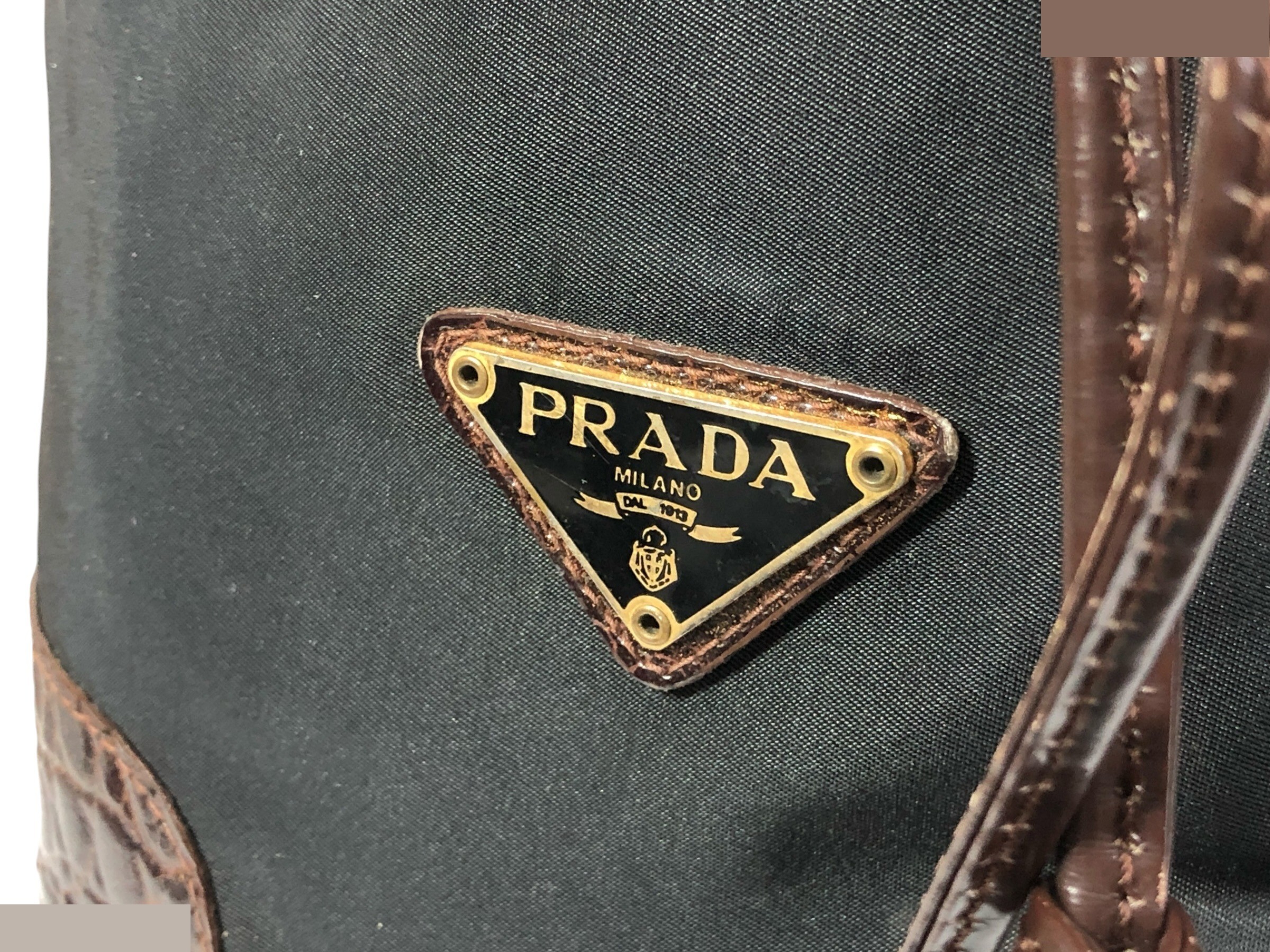 drawstring shoulder bag with triangular logo plate and crocodile embossed leather. — view 2