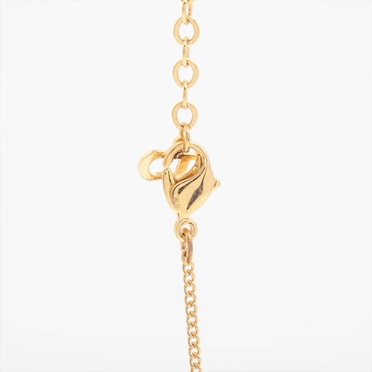 CD logo necklace, gold plated with rhinestones. Shows signs of wear, including — view 3