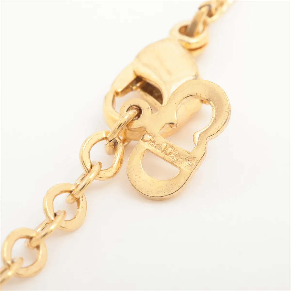 CD logo necklace, gold plated with rhinestones. Shows signs of wear, including — view 4