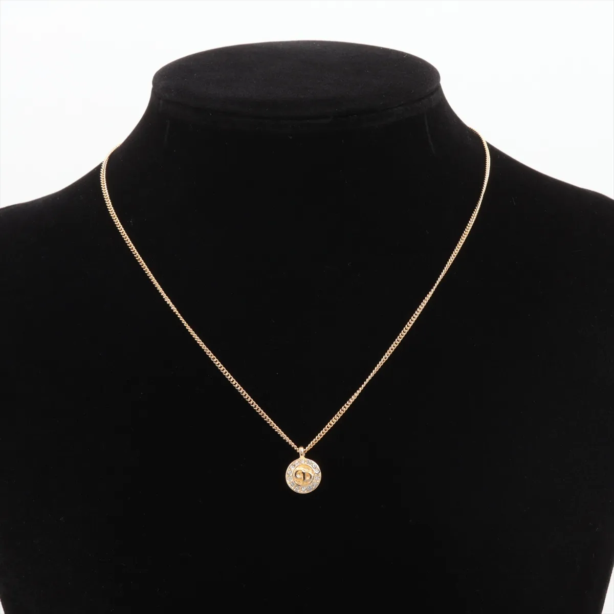 CD logo necklace, gold plated with rhinestones. Shows signs of wear, including — view 5