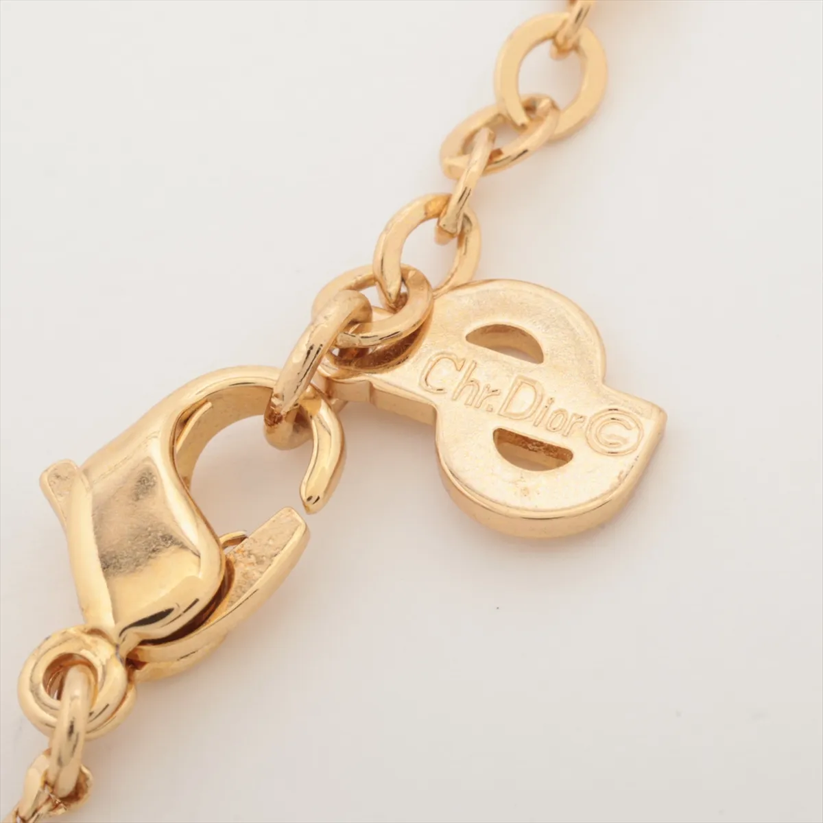 logo necklace, gold plated with rhinestones, shows signs of wear, tarnishing, — view 4
