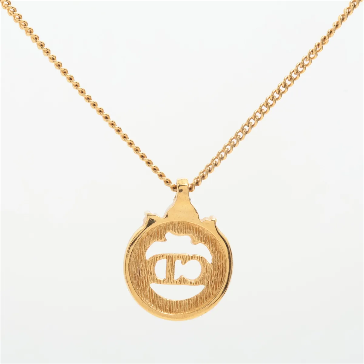 CD logo necklace, gold plated with rhinestones. Shows signs of wear, including — view 2