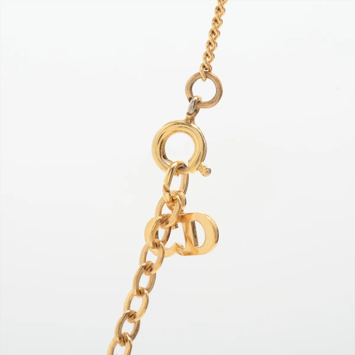 CD logo necklace, gold plated with rhinestones. Shows signs of wear, including — view 3