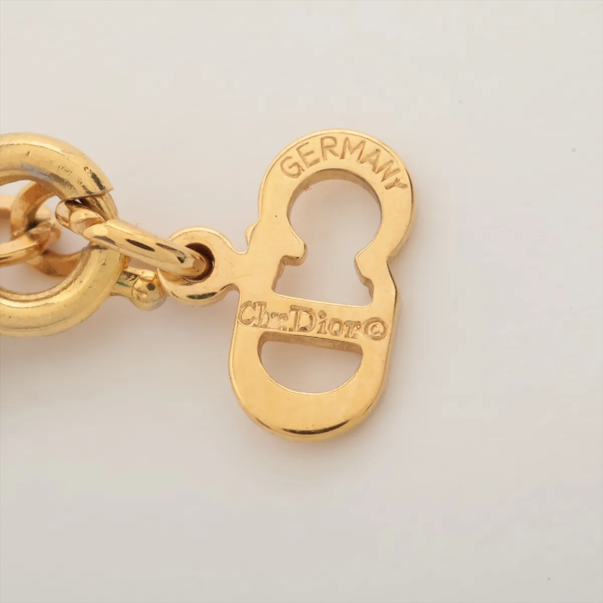 CD logo necklace, gold plated with rhinestones. Shows signs of wear, including — view 4