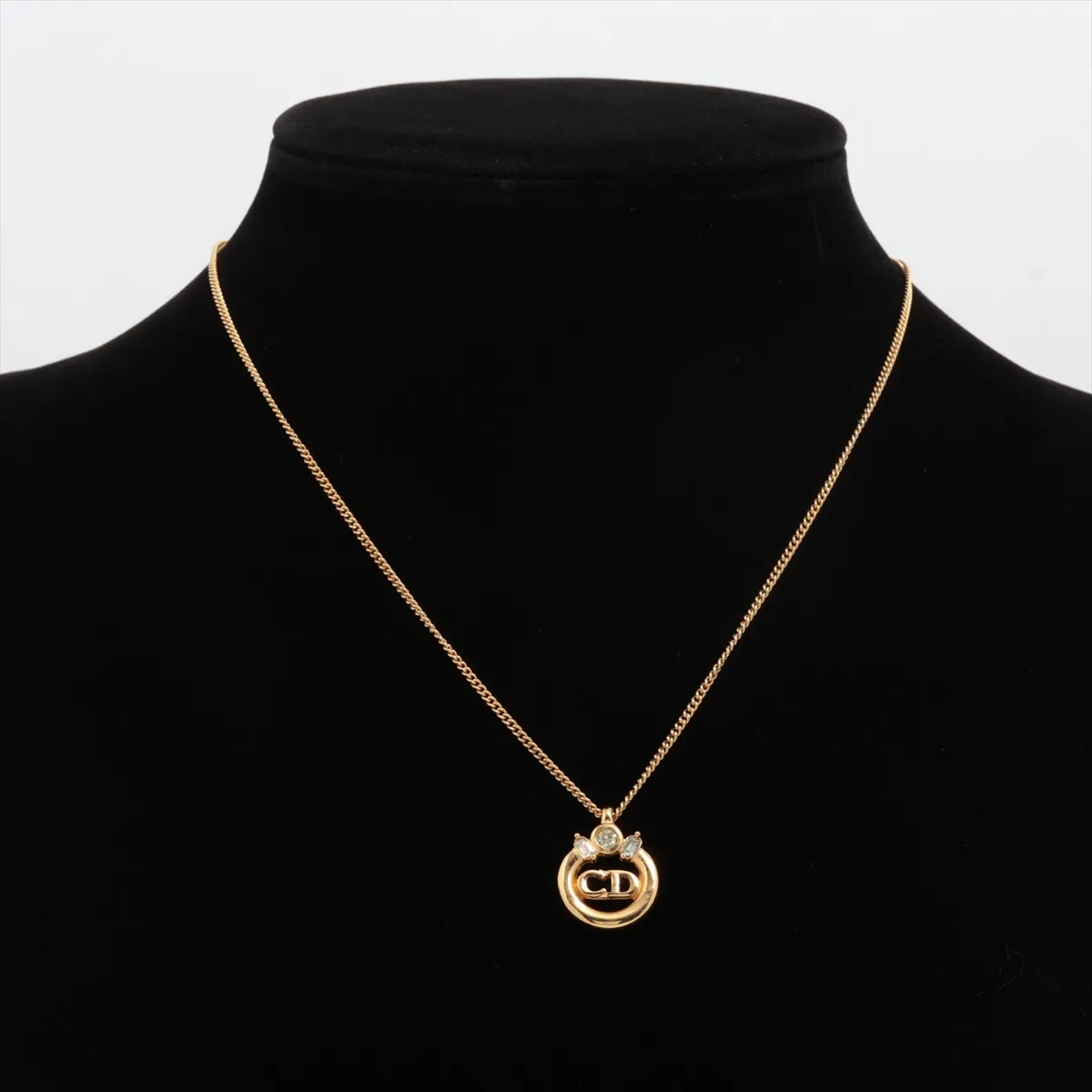 CD logo necklace, gold plated with rhinestones. Shows signs of wear, including — view 5