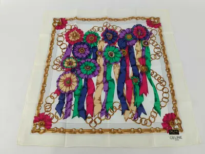 handkerchief scarf with sticker, logo, ribbon, tassel, medal motif, and other accessories.