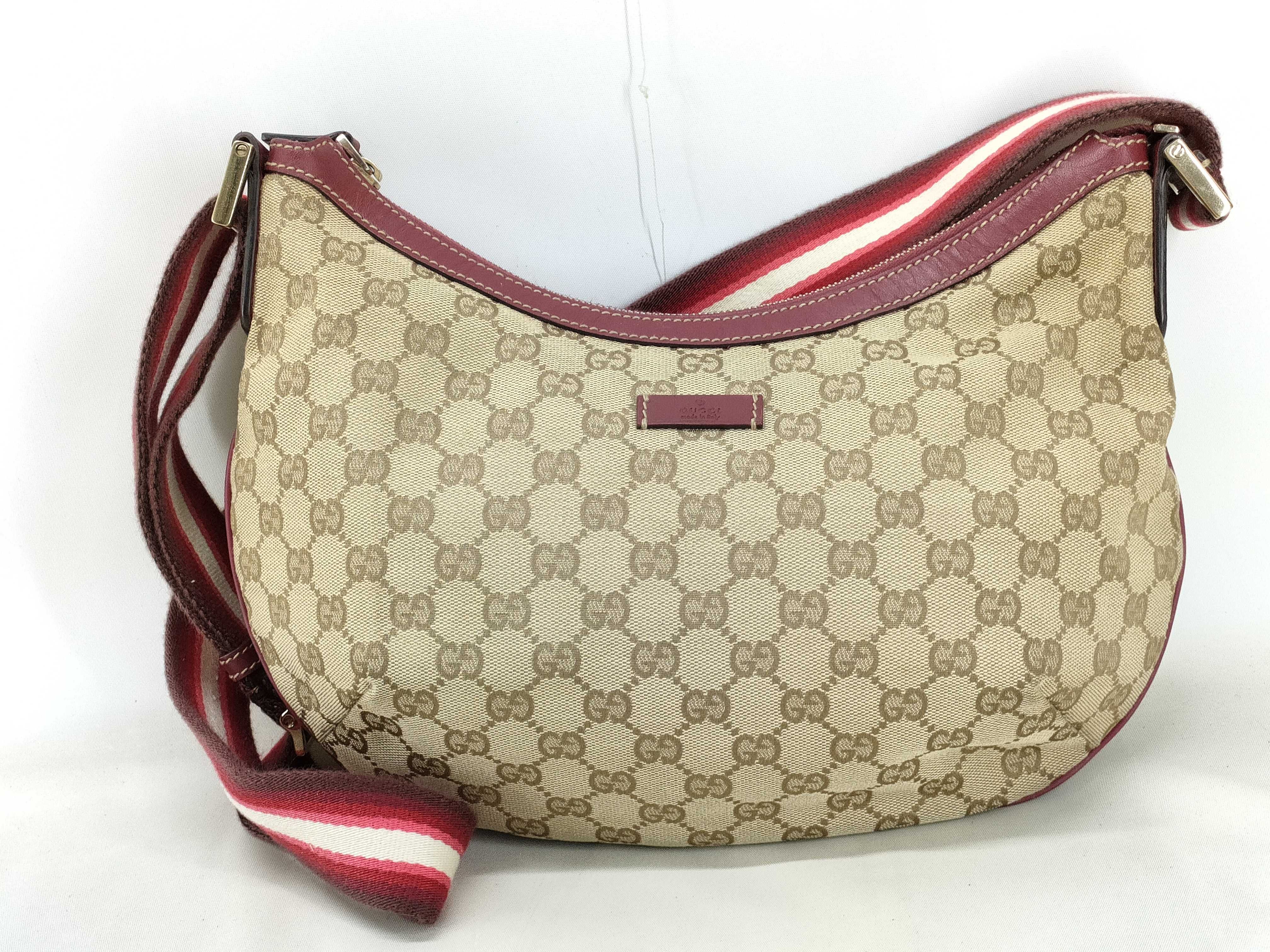 GG Canvas Shoulder Bag with GG Pattern, Webbing Strap, and Leather Trim.