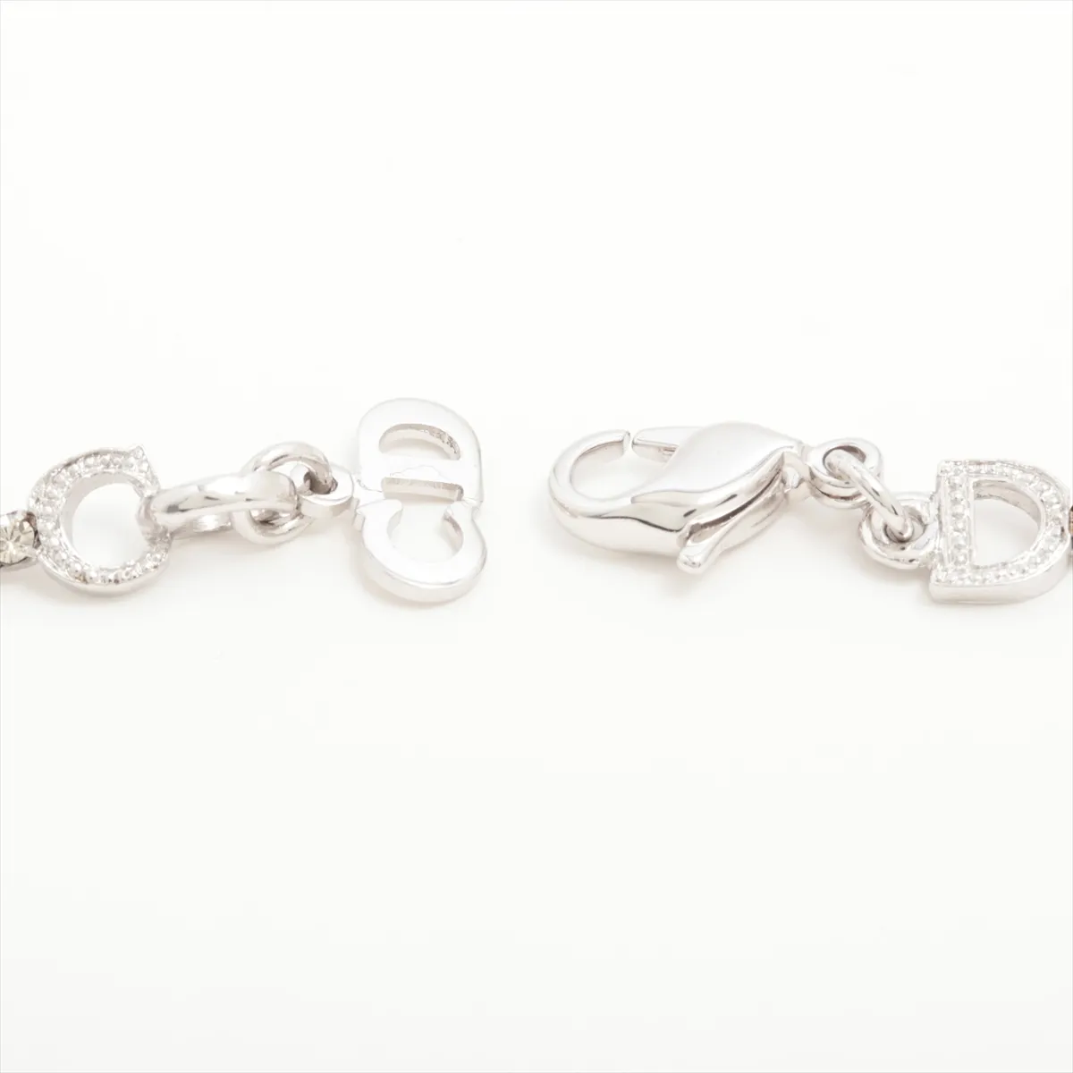 D-logo bracelet, metal and rhinestones, silver. Shows wear, tarnishing, and stains. — view 4