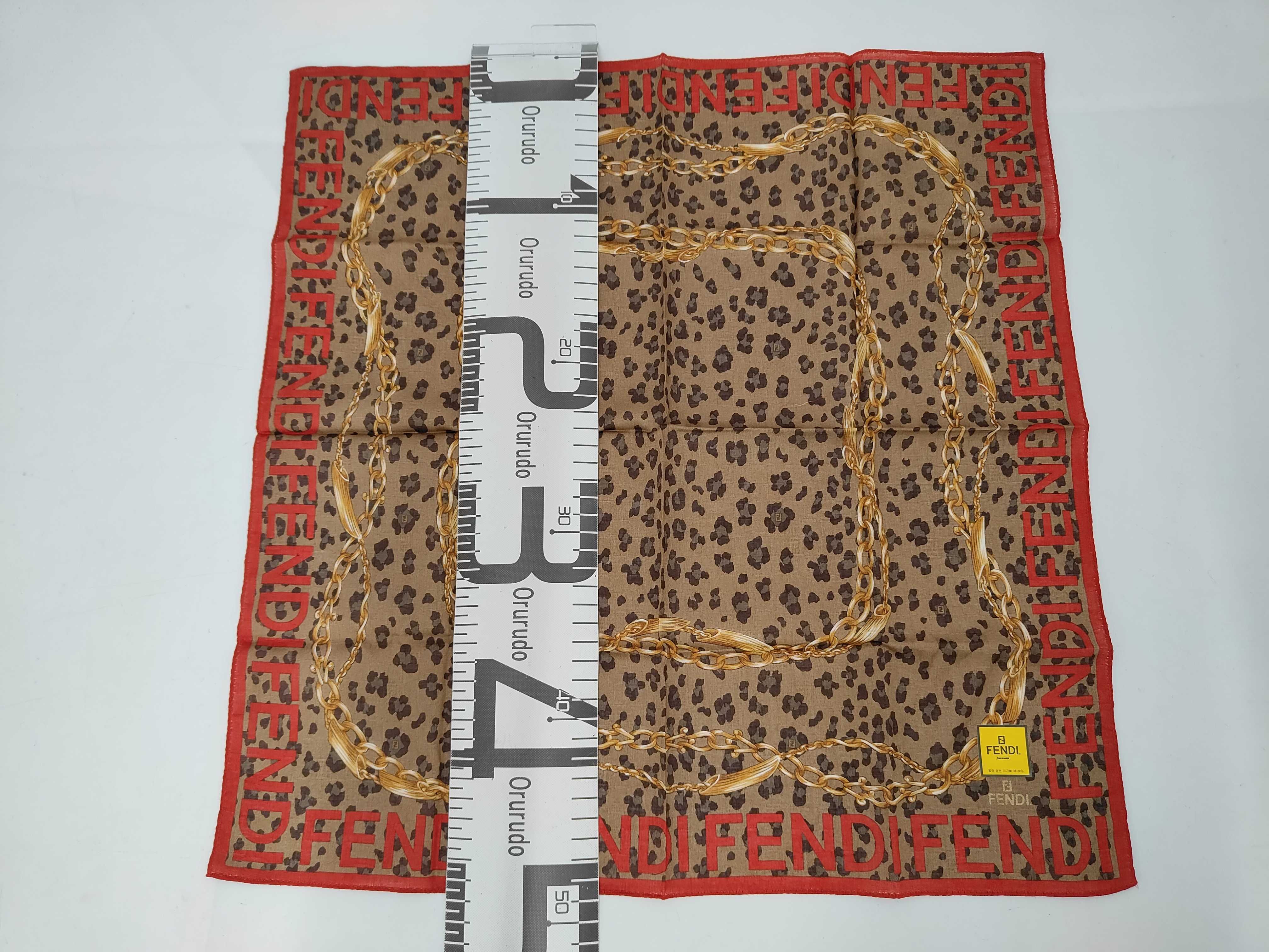 handkerchief scarf with sticker, logo border, leopard print, chain, and other accessories. — view 2