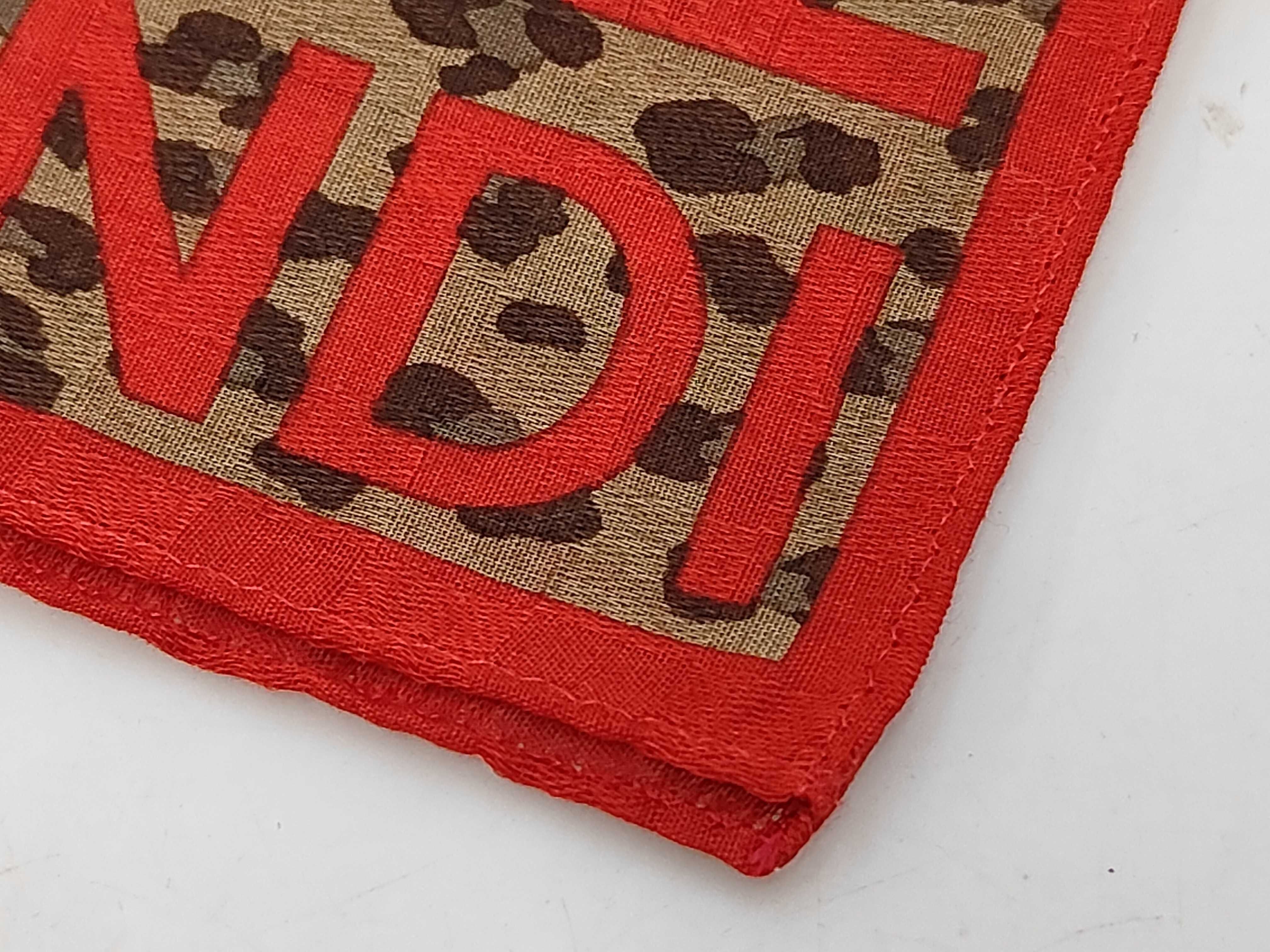 handkerchief scarf with sticker, logo border, leopard print, chain, and other accessories. — view 4