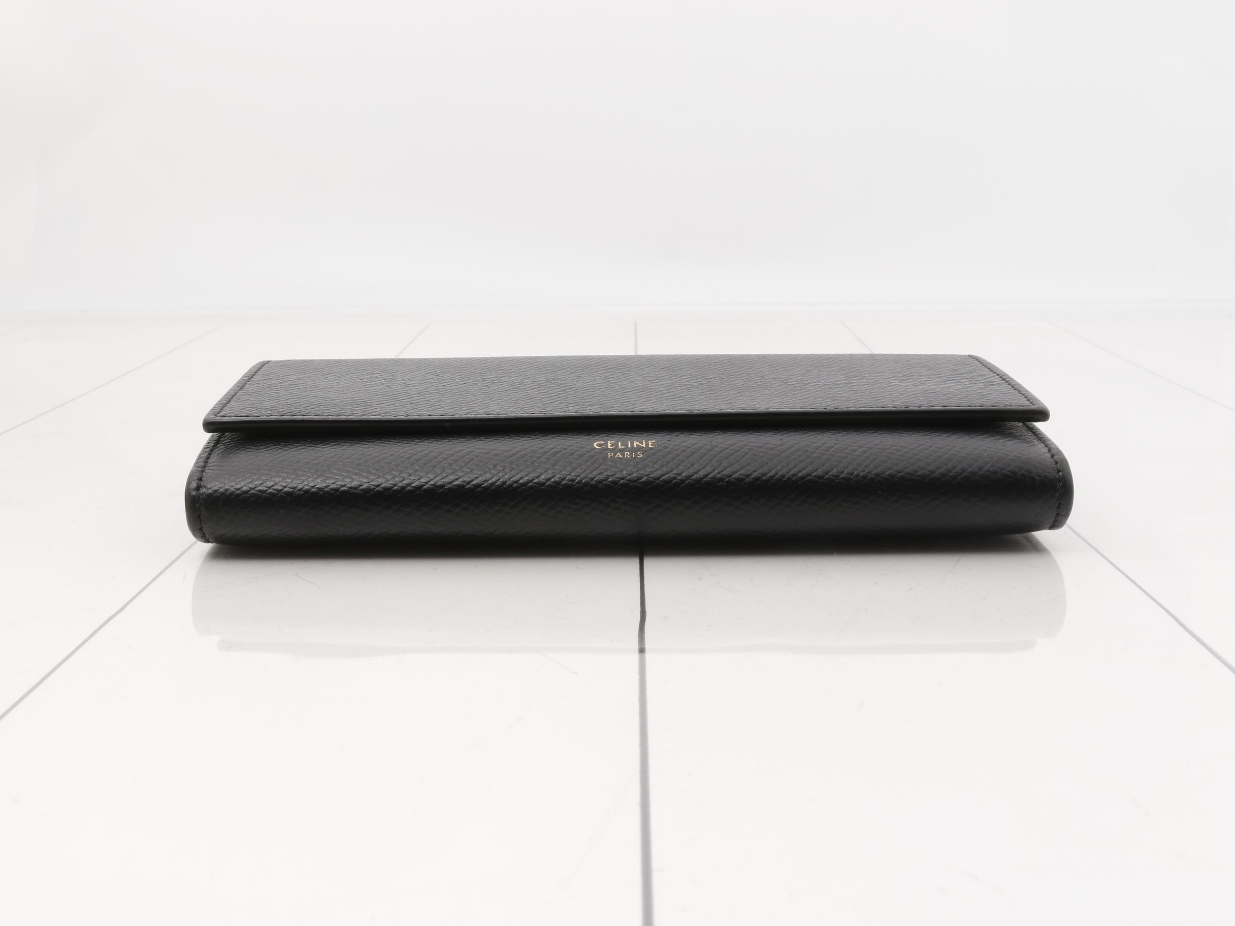 Black bag and wallet with gold hardware. — view 3