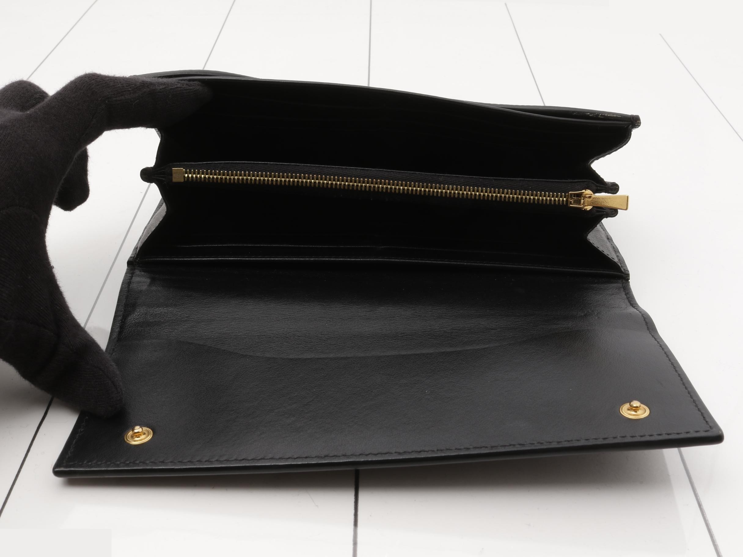 Black bag and wallet with gold hardware. — view 4