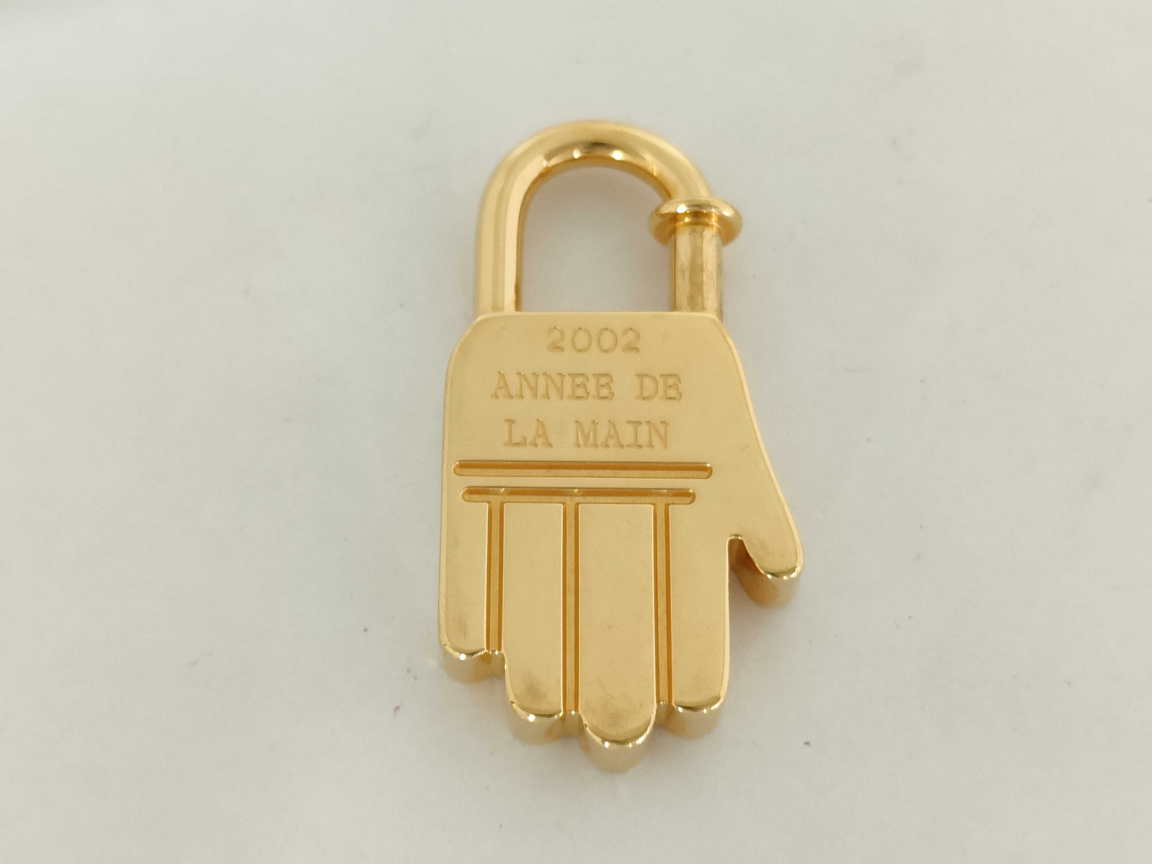 Handbag with Padlock, GP, and other accessories.