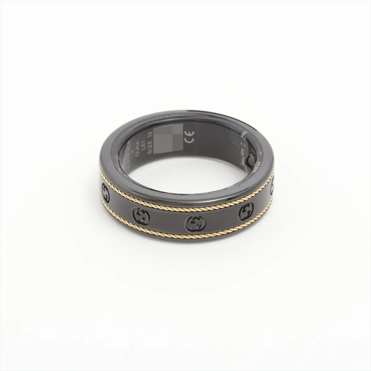 x Aura Interlocking G Ring, Size 12, Titanium, Black x Gold, some wear and tarnishing, includes wireless charging cable. — view 2
