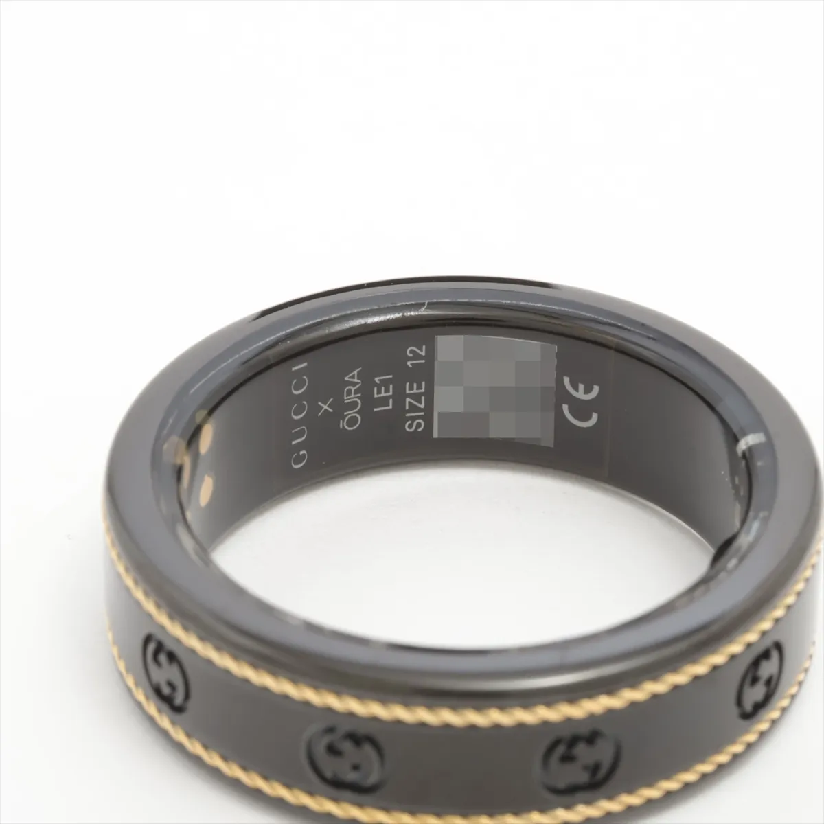 x Aura Interlocking G Ring, Size 12, Titanium, Black x Gold, some wear and tarnishing, includes wireless charging cable. — view 3