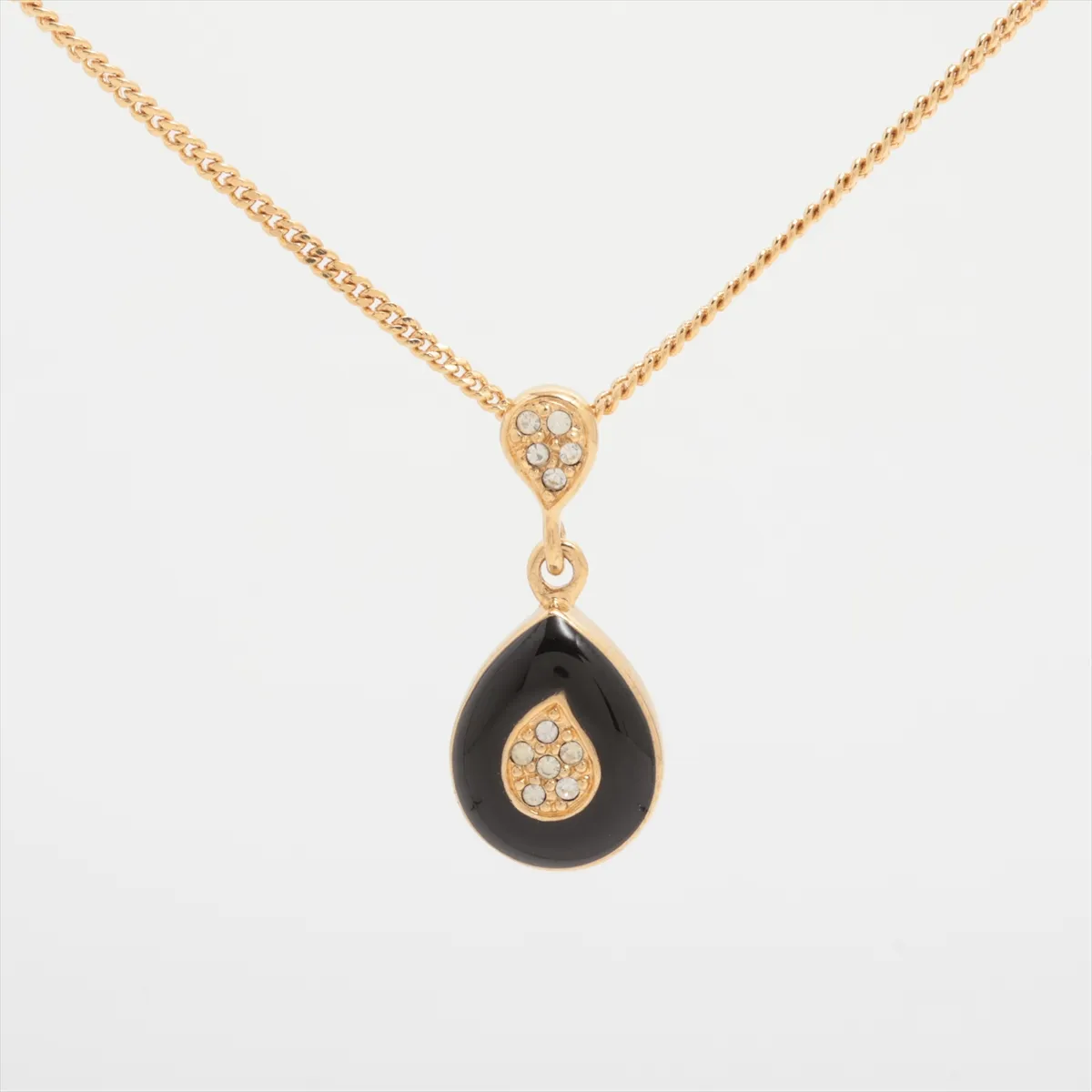 necklace, gold and black, with rhinestones. Shows signs of wear, tarnish, and stains.