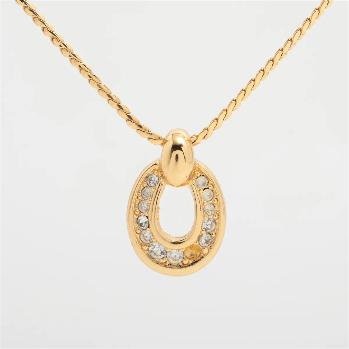 necklace, gold plated with rhinestones. Shows signs of wear, tarnishing,
