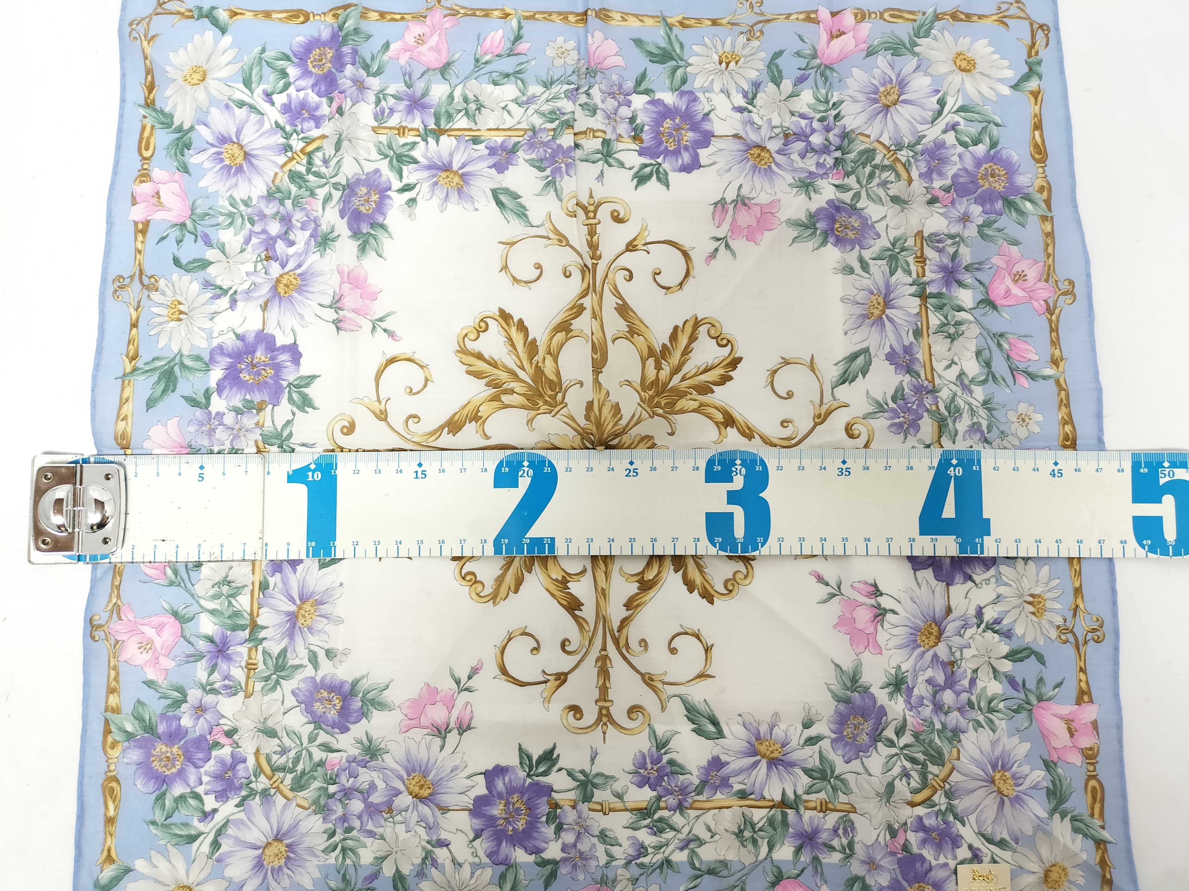 handkerchief scarf with sticker, floral design, and other accessories. — view 2