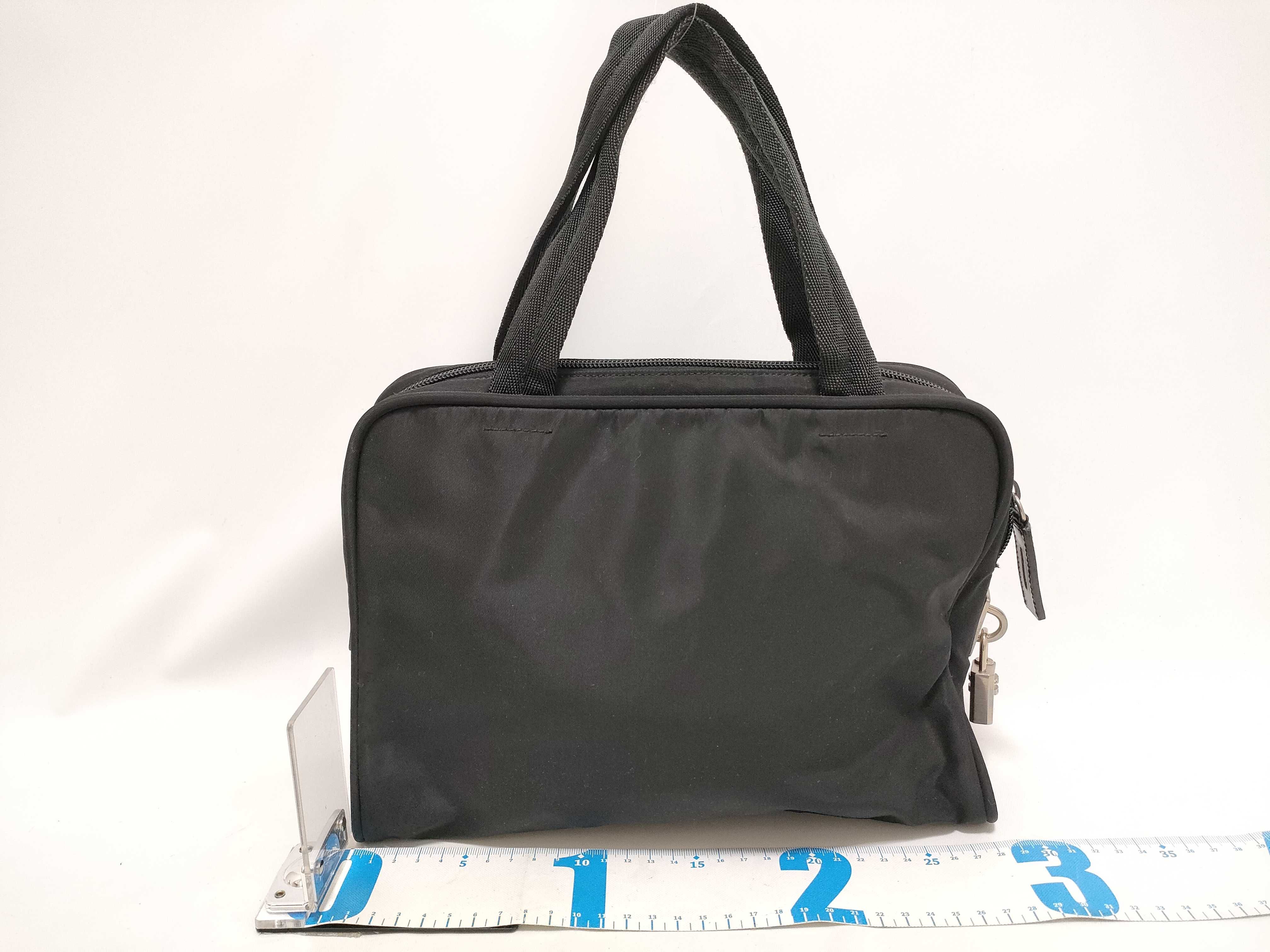 nylon handbag, black nylon, with clochette, guarantee card, and padlock. — view 2