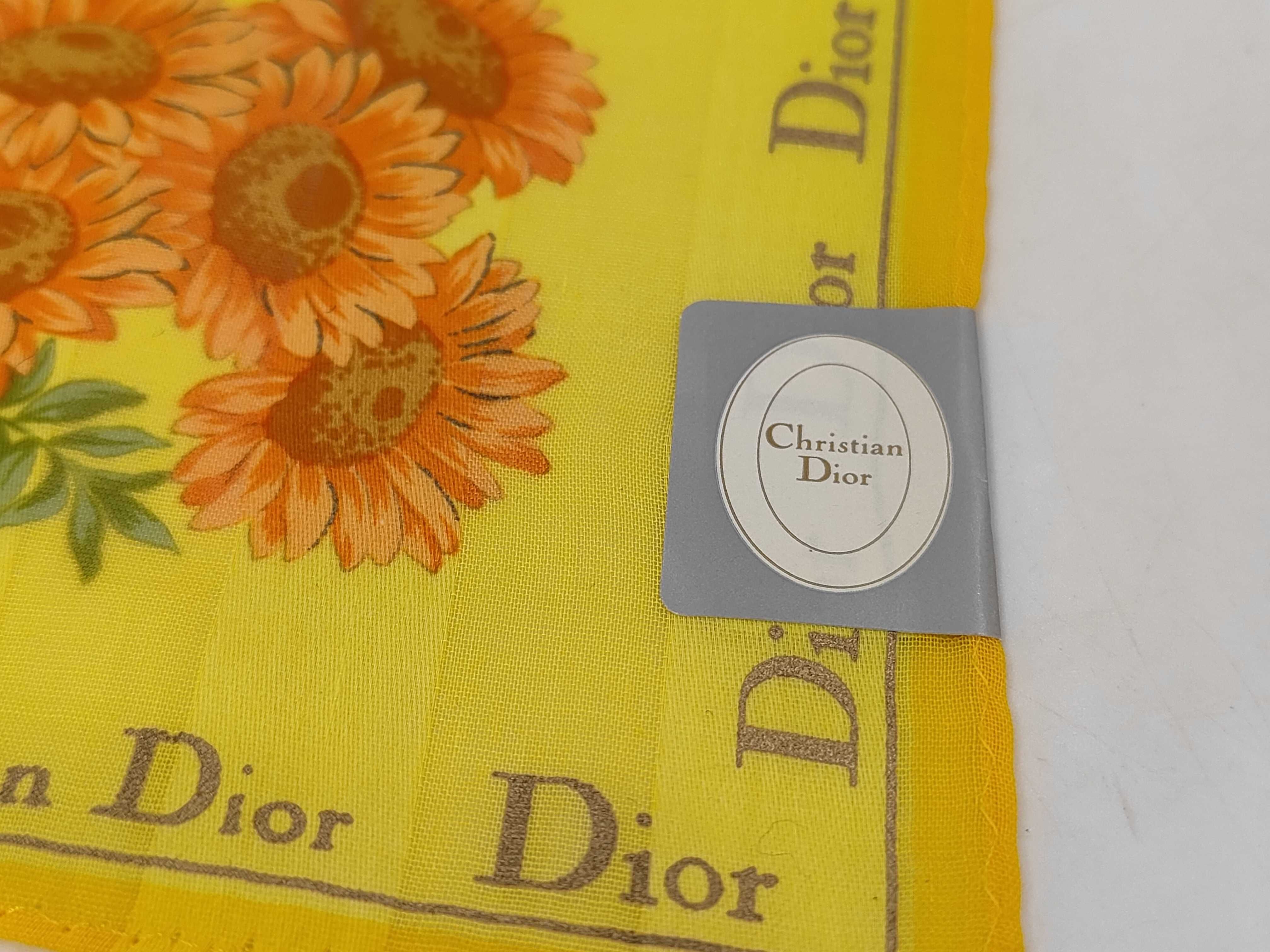 handkerchief scarf with sticker, border logo, floral pattern, orange, and other accessories. — view 3