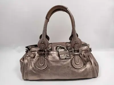 Paddington handbag, gold, includes padlock and key.