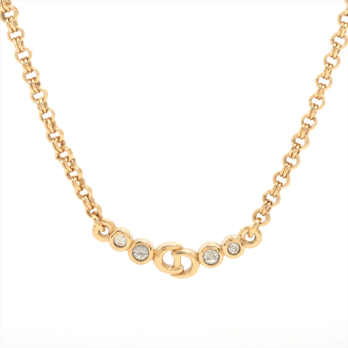 CD logo necklace, gold plated with rhinestones. Shows signs of wear, including
