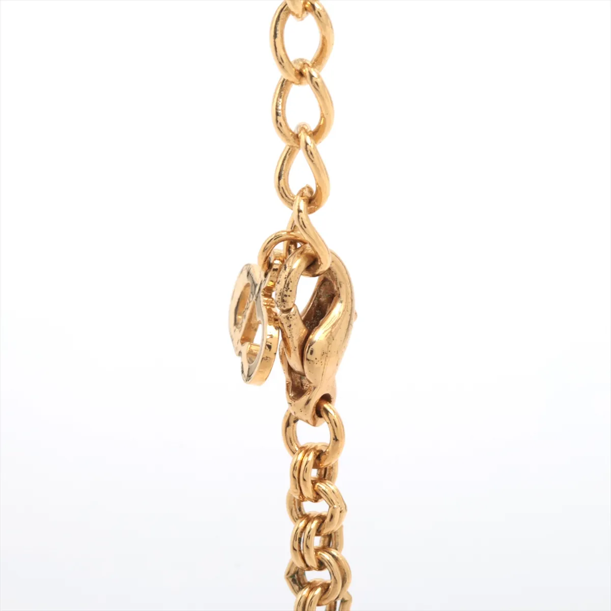 CD logo necklace, gold plated with rhinestones. Shows signs of wear, including — view 3