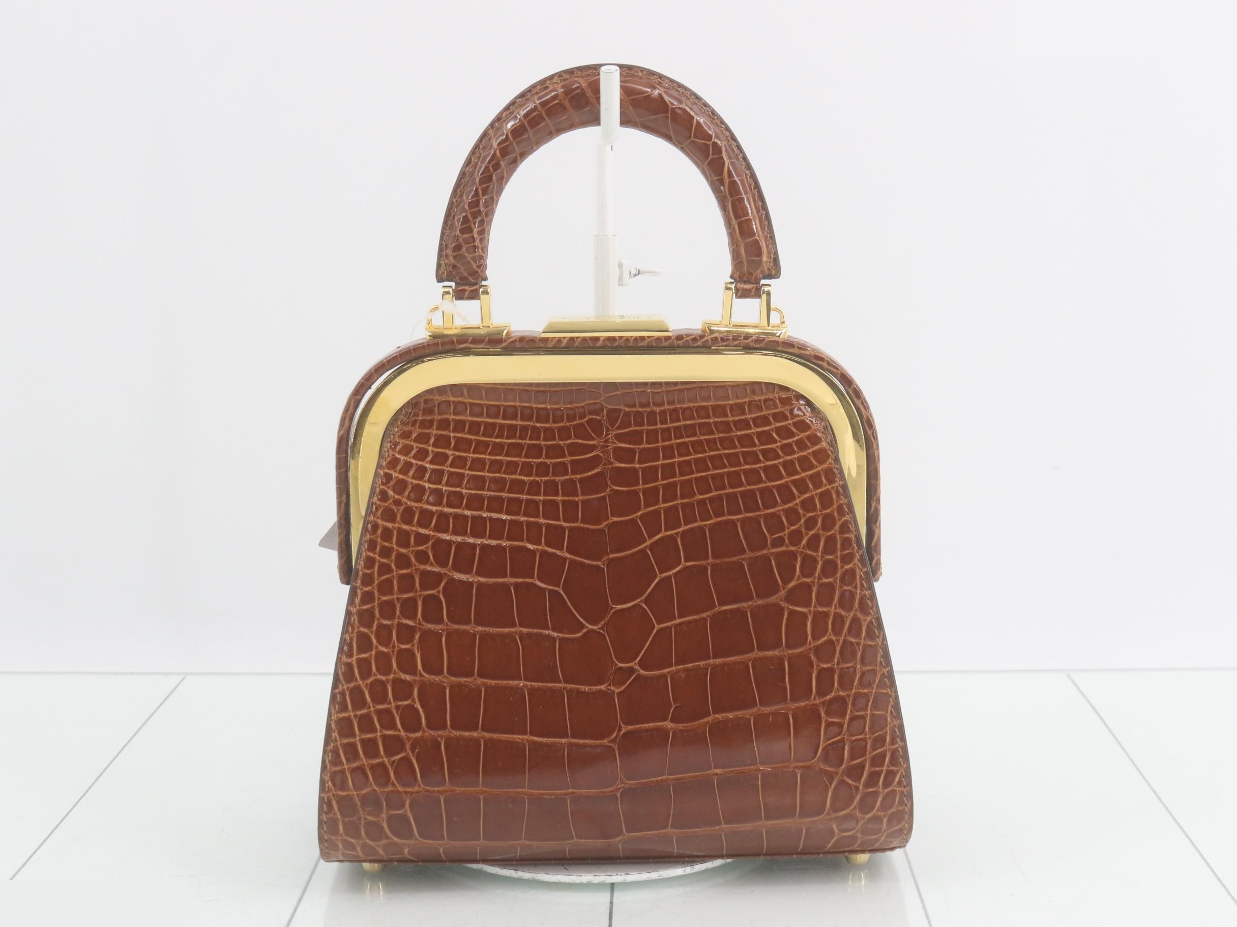 Crocodile-embossed handbag with gold hardware, brown tones. — view 2
