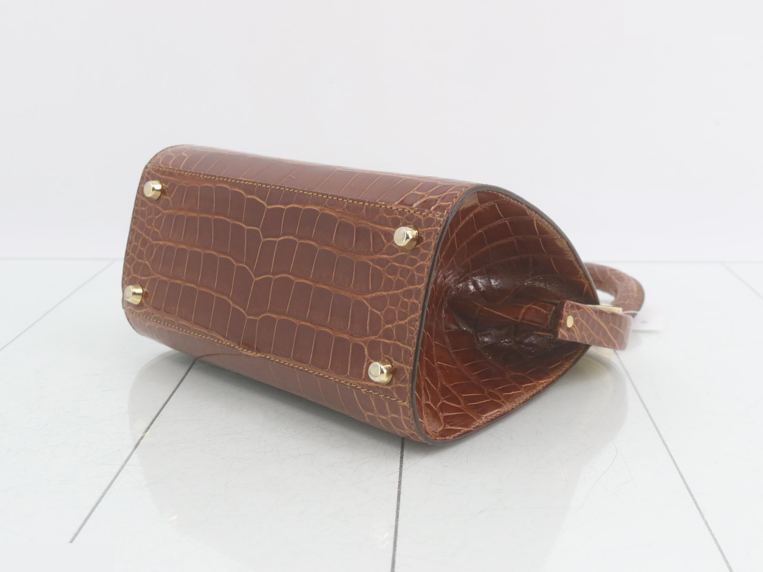 Crocodile-embossed handbag with gold hardware, brown tones. — view 6