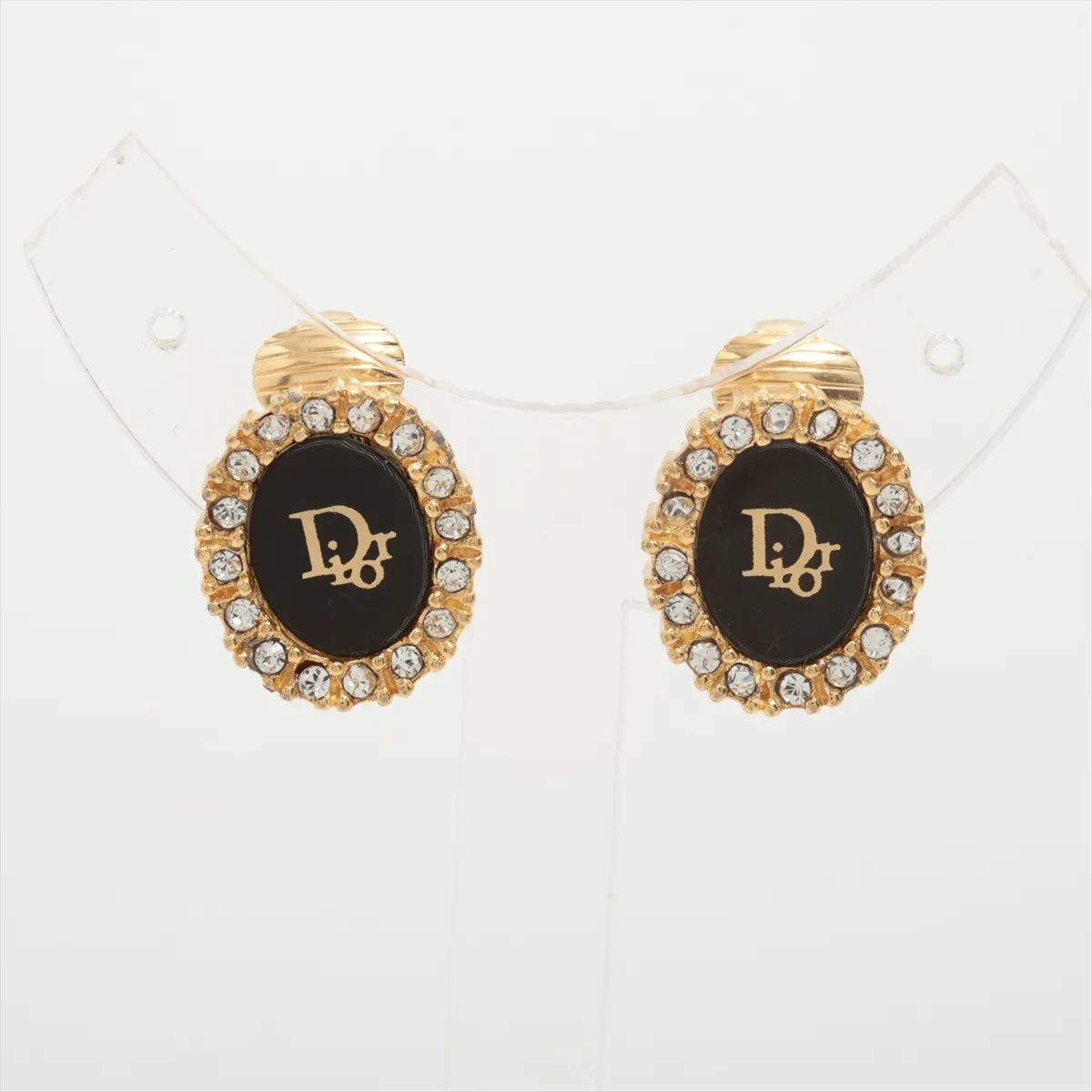 logo earrings (for both ears), gold-plated with rhinestones. Shows signs of wear, tarnishing,