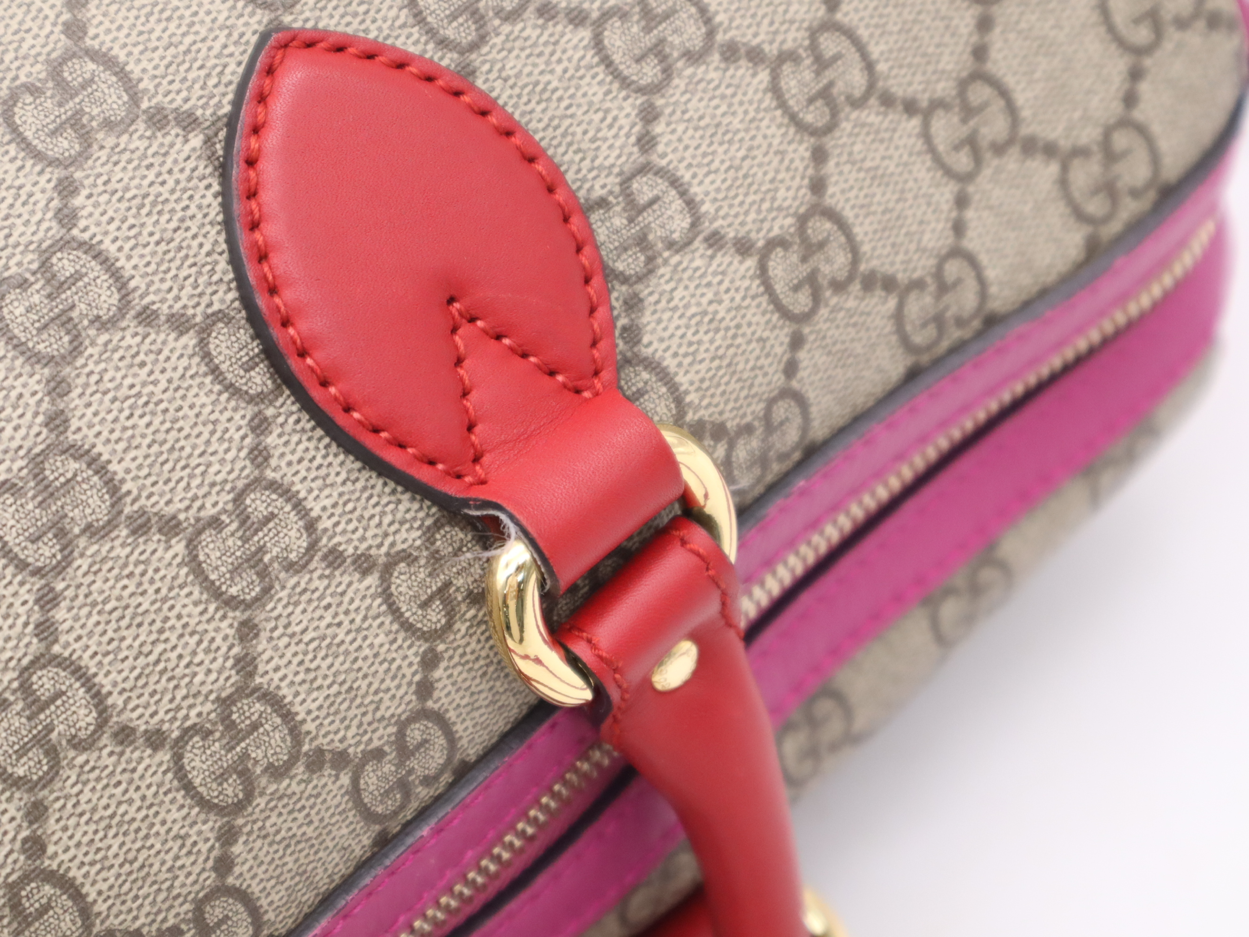 409527 GG Supreme 2-way Boston bag in beige, pink, and red with gold hardware and shoulder strap. — view 8