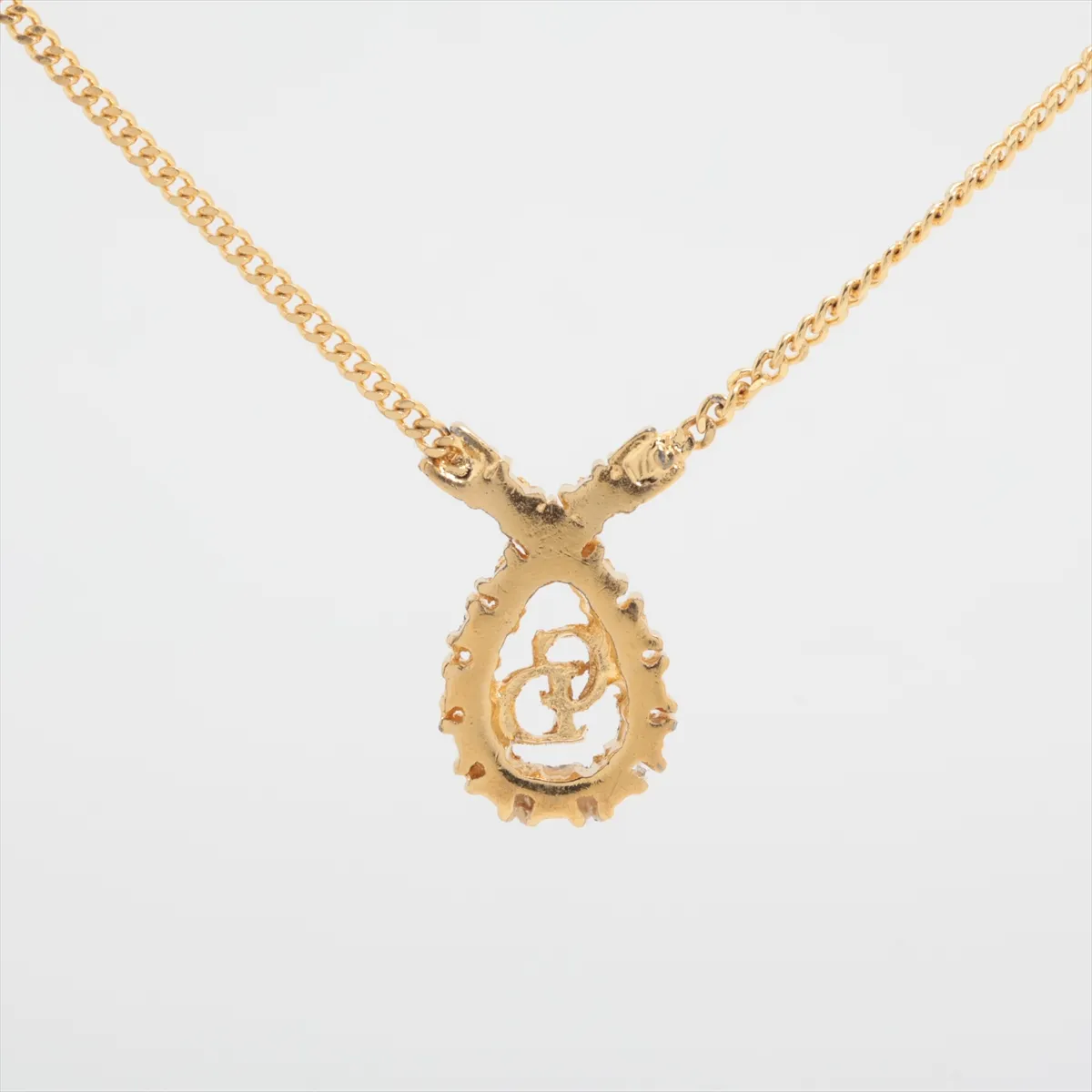 CD logo necklace, gold plated with rhinestones. Shows signs of wear, including — view 2