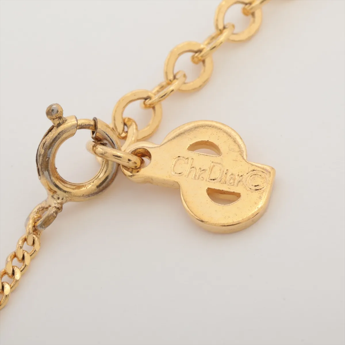CD logo necklace, gold plated with rhinestones. Shows signs of wear, including — view 4