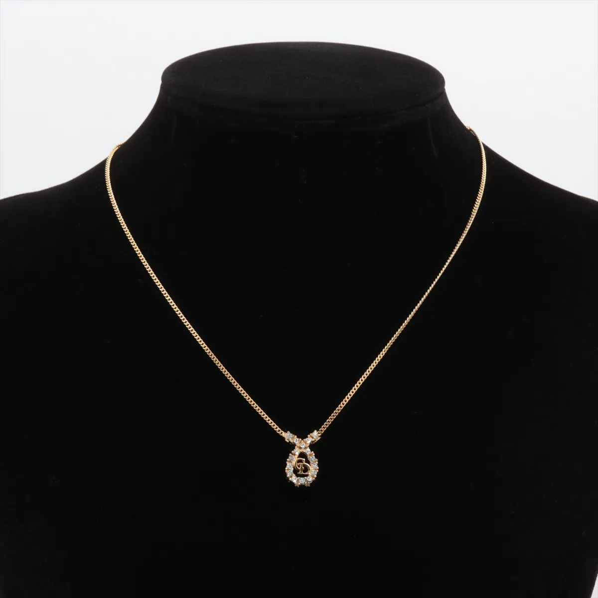 CD logo necklace, gold plated with rhinestones. Shows signs of wear, including — view 5