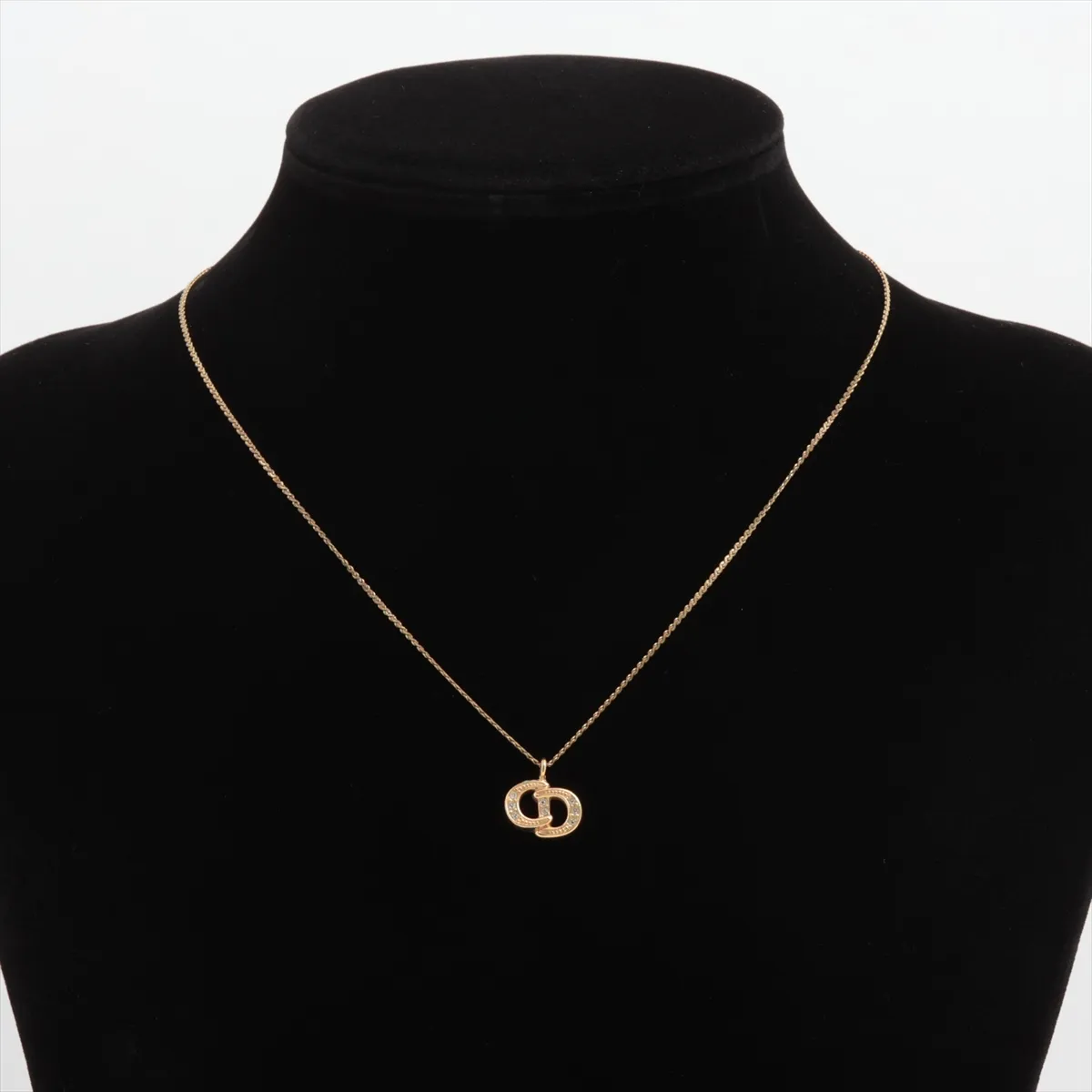 CD logo necklace, gold plated with rhinestones. Shows signs of wear, including dents, — view 5