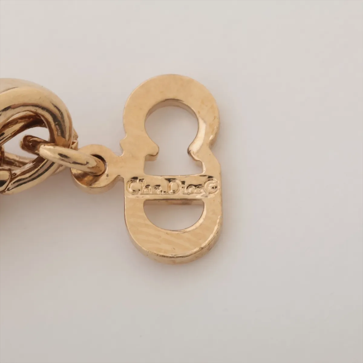 CD logo necklace, gold plated with rhinestones, shows signs of wear, tarnishing, — view 4