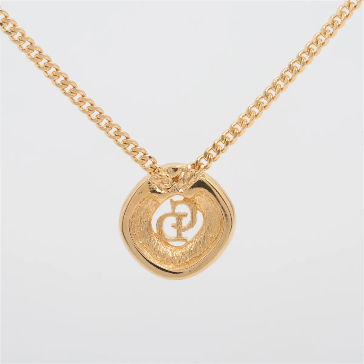 CD logo necklace, gold-plated with rhinestones. Shows wear, tarnishing, and stains. — view 2