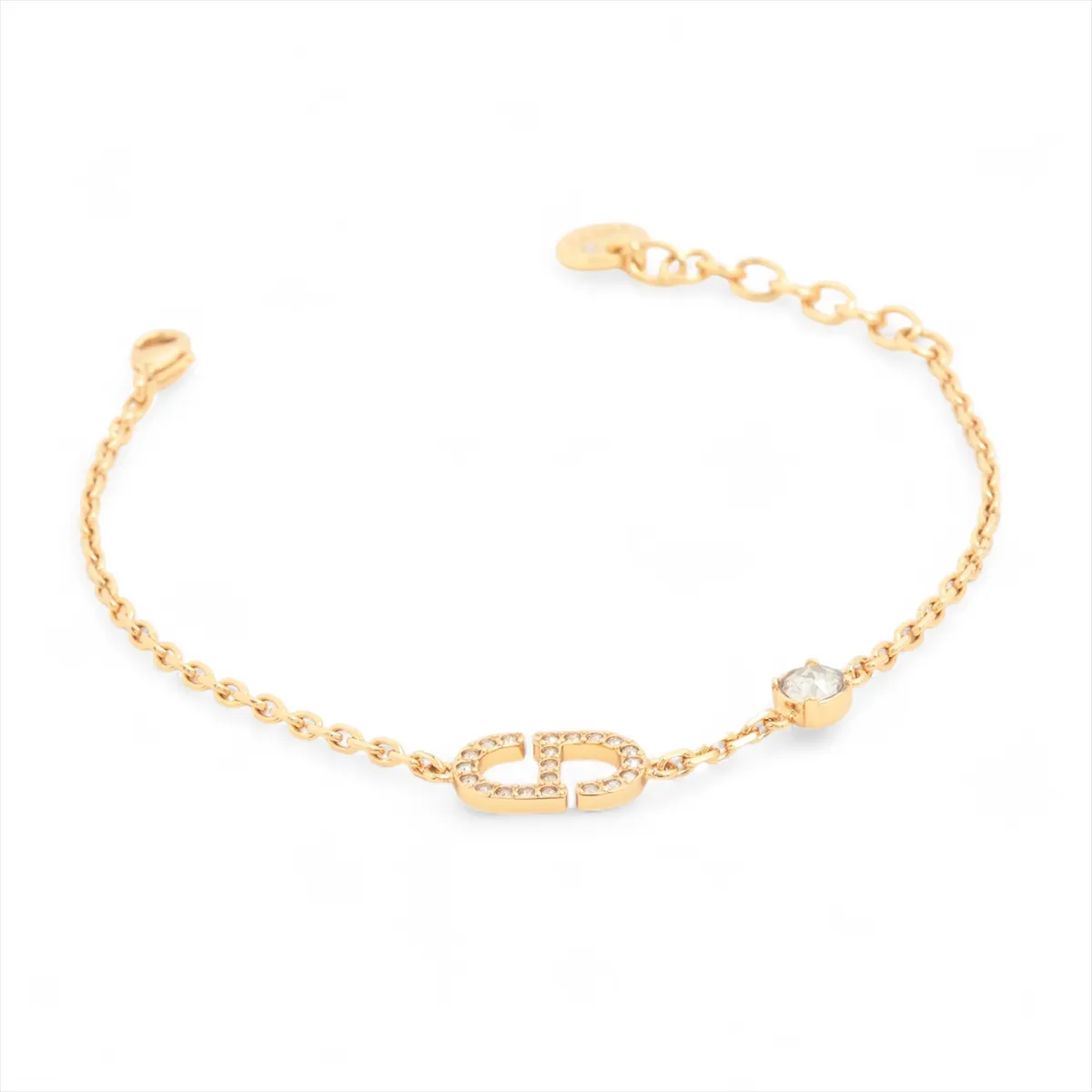 Petit CD bracelet, gold-plated with rhinestones. Shows signs of wear including