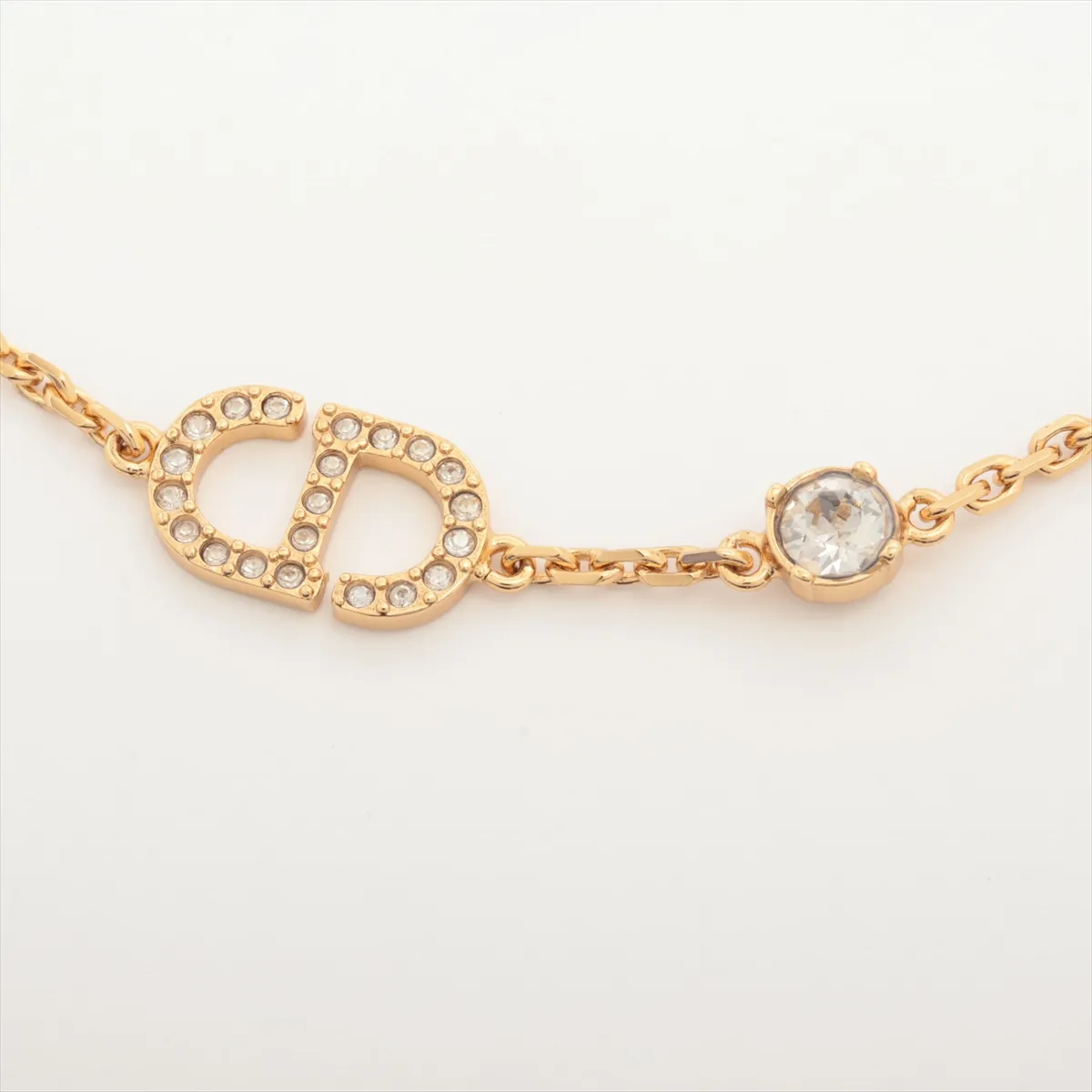 Petit CD bracelet, gold-plated with rhinestones. Shows signs of wear including — view 2