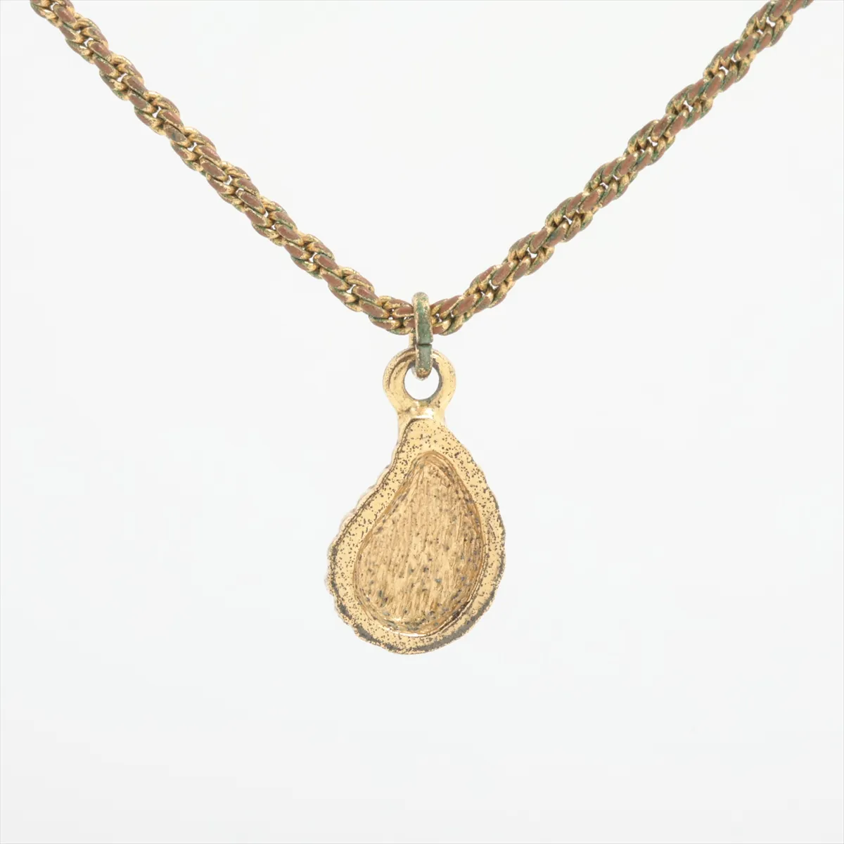teardrop necklace, gold plated with colored stones, gold and green. Shows signs of wear, including — view 2