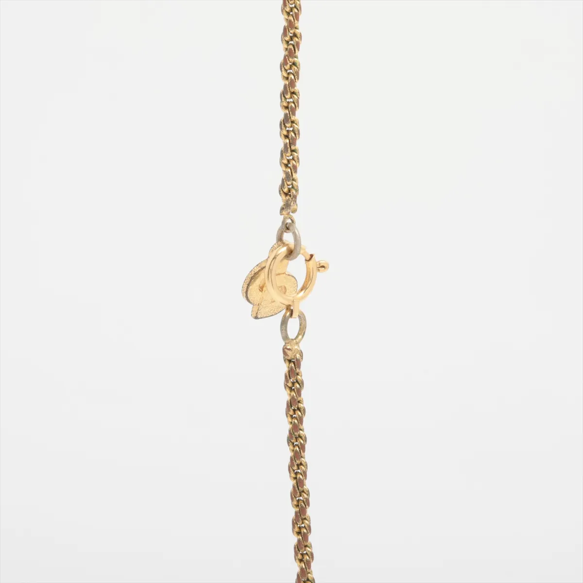 teardrop necklace, gold plated with colored stones, gold and green. Shows signs of wear, including — view 3