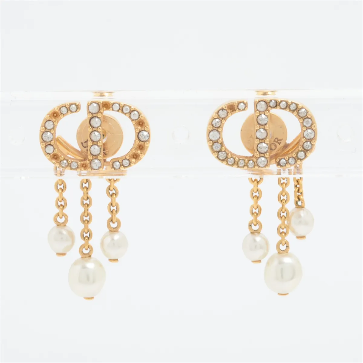 CD Navy earrings (for both ears), gold-plated with rhinestones and faux pearls. Shows signs of wear including