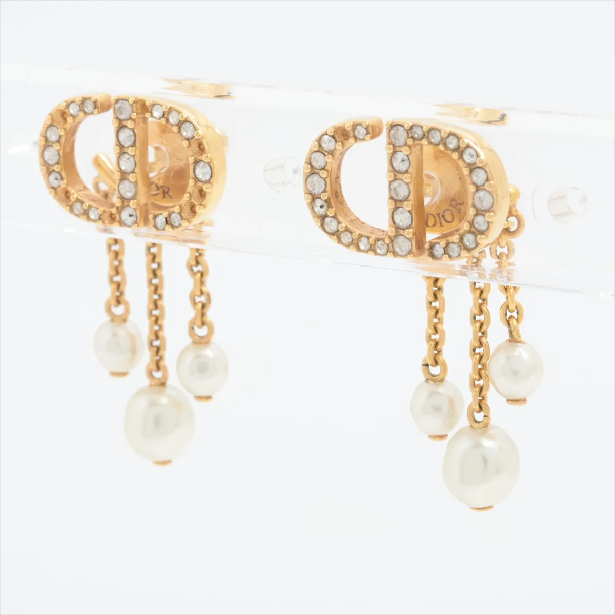 CD Navy earrings (for both ears), gold-plated with rhinestones and faux pearls. Shows signs of wear including — view 3
