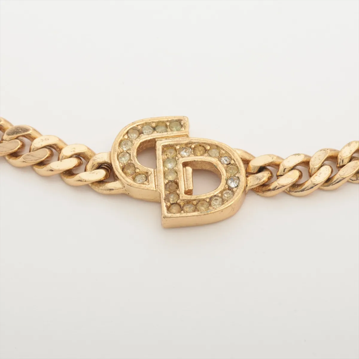 CD logo bracelet, gold plated with rhinestones. Shows signs of wear including — view 2